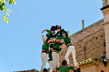 Igualada, Barcelona; 28 de abril de 2019: Das de Castelleras de Barcelona. 24 aniversario del grupo Moixiganguers de Igualada, Castellers de Sant Cugat clipart