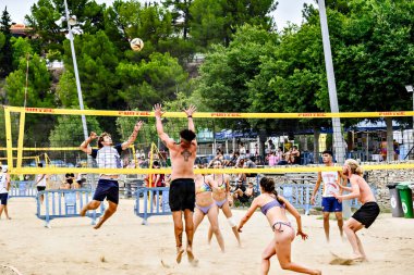 Igualada, Barcelona, İspanya; 13 Temmuz 2024: Şehirde plaj voleybolu oynayan bir grup insan. Spor ve eğlence.