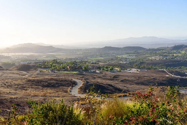 View from above of a rolling rural landscape dotted with ranches and farms in California at sunset in autumn. Simi Valley, CA, USA.