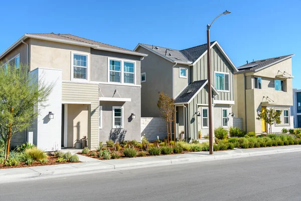 Row of modern detached houses in a housing development in California on a clear autumn day. Santa Clarita, CA, USA.