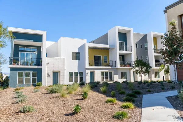 Modern newly-built row houses in a housing development in California on a clear autumn day. Santa Clarita, CA, USA.