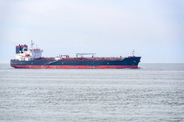 Oil tanker approaching a harbour on a cloudy summer day. Rotterdam, Netherlands.