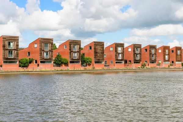 Modern detached houses in a housing development on a cloudy summer day. Groningen, Netherlands.