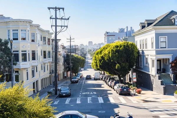 stock image Straight tree lined street through a residential district on a sunny autumn day. San Francisco, CA, USA.