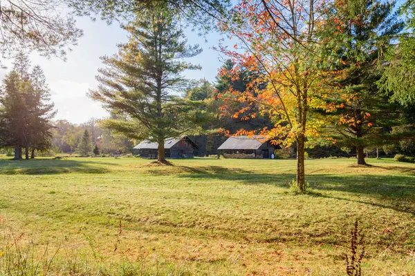 stock image Old wooden barns in a forested rural landscape in the mountains on a sunny autumn day. Catskill Mountains, NY, USA.