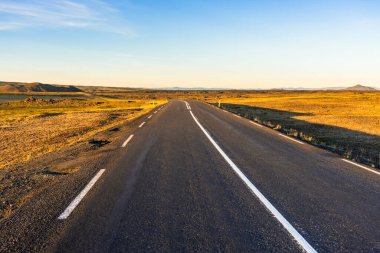 Empty road midnight sun light in summer Diamod circle route, Iceland. clipart