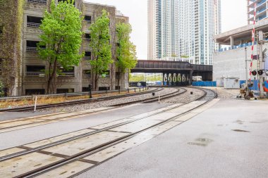Yağmurlu bir bahar gününde Chicago şehir merkezinde bir kavşakta terk edilmiş tren rayları. Illinois, ABD.