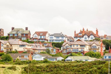 Bulutlu bir yaz gününde bir yerleşim bölgesinde evler ve apartmanlar. New Brighton, Wallasey, İngiltere, İngiltere.
