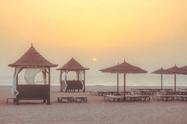 stock image beautiful tropical beach with sea and umbrella on sunset time for travel and vacation