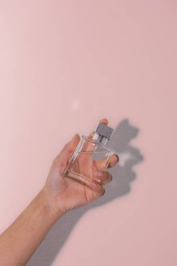 Kadın eli ile parfüm şişesi