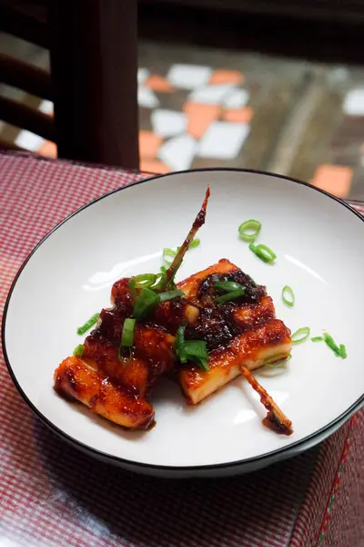 stock image Homemade tteokkochi, Korean traditional street food made from rice cake grilled with spicy sauce