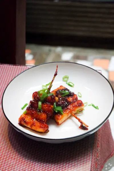 stock image Homemade tteokkochi, Korean traditional street food made from rice cake grilled with spicy sauce