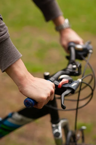 stock image Hand on a bicycle handlebar. Bike bell. Hand holds a bicycle brake. Cycling trip. Bicycling. Braking.