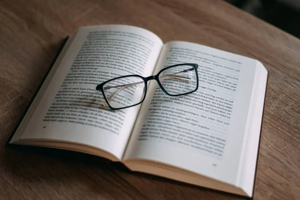 stock image Glasses and books placed on table in the living room .Educational concepts and knowledge