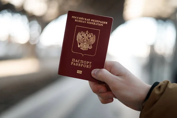 Russian passport on a black travel suitcase, selective focus. Emigration of Russians from the country, problems with visas, refugees