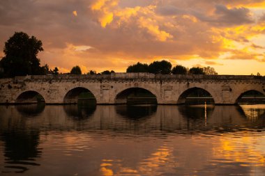 Discover the iconic Ponte di Tiberio, a Roman bridge spanning the River Marecchia in Rimini, Italy. Built in 20 AD, this majestic structure is a testament to Roman engineering and a must-see clipart