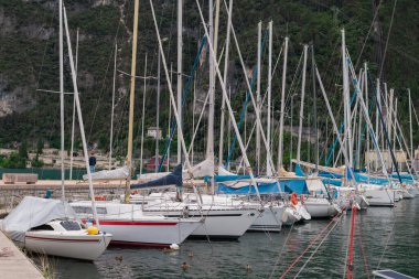 Idyllic lake Garda coastline and mediterranean village with sailboats, Italy