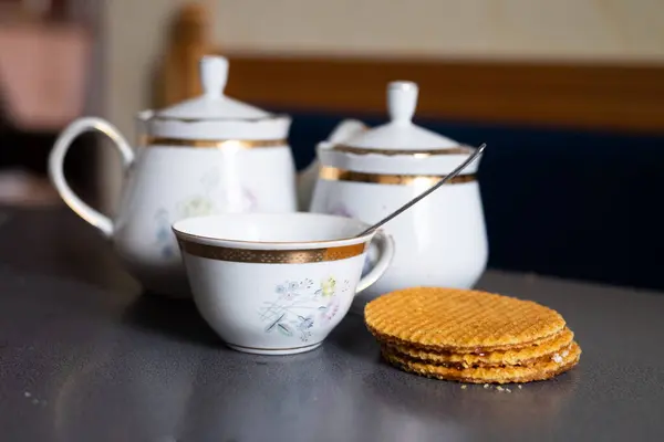 Sweet breakfast in cozy cafe. Enjoy delicious pancakes, waffles, fresh fruits and a cup of tea on table. Perfect for any project related to breakfast, cafe, and food.
