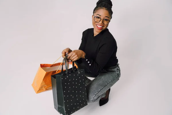 stock image Shopping Concept - Portrait of young beautiful attractive African woman smiling and joyful with shopping bags.