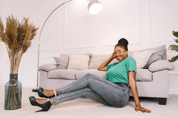 stock image Portrait of attractive black woman smiling and happy on light gray background, African American woman wearing green top