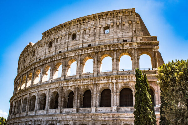 The Colosseum is an l amphitheatre in the centre of Rome, Italy, next to the Roman Forum. It is the largest ancient amphitheatre.