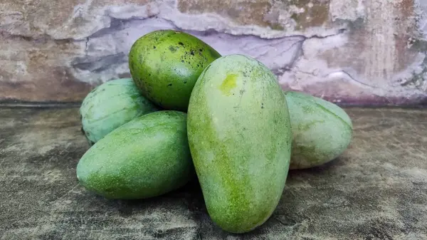 stock image A group of green mangoes