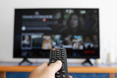 Yeni bir film ararken uzaktan kumandalı bir el.