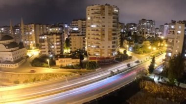 Evening time lapse of traffic driving through central Mersin in Turkey. Mosque. Night city. Car lights. Time lapse. High quality 4k footage