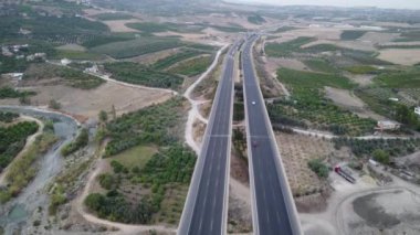 4K Hava Aracı Mersin Viaduct. Dağların 4K 'sındaki hava manzarası ve arabalarla karayolu. Mersin. Hindi. Yolculuk, yol dönüşleri, günbatımı. Yüksek kaliteli görüntüler