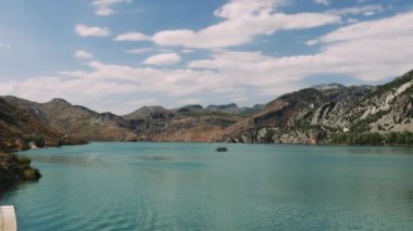 Hava manzarası: Dağlar ve ormanlarla çevrili temiz turkuaz sularla birlikte Türkiye 'deki Yeşil Kanyon' da turistlerin yelken açtığı turistik bir tekne. Yüksek kalite 4k görüntü