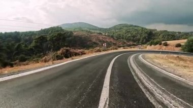 Siyah asfalt ve taze beyaz işaretlerle dağ yolunda sür. Arabayla seyahat, birinci şahıs manzaralı. POV ulaşım aracı ileri. Yüksek kalite 4k görüntü