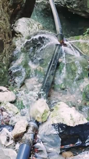 Water Pipe Accident Captured Intense Burst Leaking Pipe Amidst Stones — Stock Video