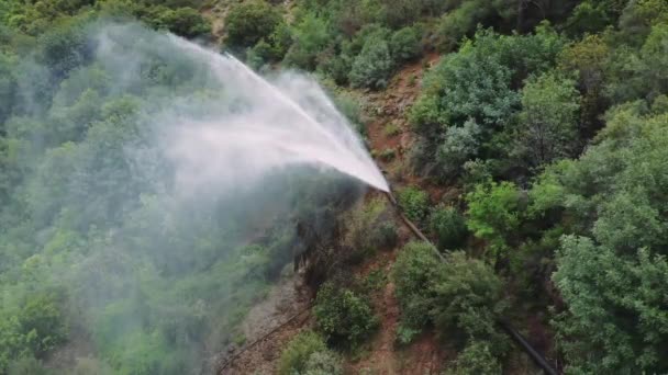 无人机抓住喷泉 管道爆裂在高山峡谷中 从空中看喷泉 管道放水 可视化显示喷泉 管道中断在绿色的地形 高质量的4K镜头 — 图库视频影像