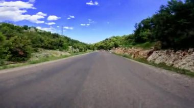 Dolambaçlı bir dağ yolu boyunca yükselen çamların arasından manzaralı bir yolculuk..