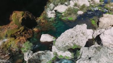 Engebeli kayalık araziden akan el değmemiş şelale yeşil bitki örtüsüyle kaplanmış, vahşi doğanın çarpıcı doğal güzelliğini gözler önüne seriyor.