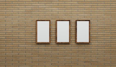 Üç boş ahşap çerçeve bir tuğla duvara karşı