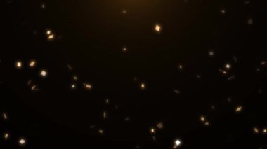 Siyah arka planda turuncu ve sarı konfeti. Parçacıklar parıldıyor ve ışıkta parıldıyor. Tatil, doğum günü, düğün, parti, yeni yıl için şenlik arka planı