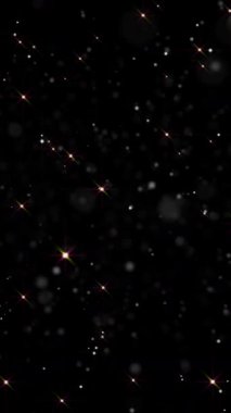 Karanlık bir zemin karşısında parıldayan yıldızların çarpıcı gösterisi büyüleyici bir atmosfer yaratır. Telefonlar için dikey duvar kağıtları