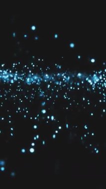 Parlak mavi parçacıklar karanlık bir arkaplanda dans ederek büyüleyici bir soyut ekran oluştururlar..