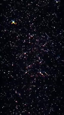 Karanlık bir kozmik arka planda ışıldayan yıldızların büyüleyici soyut animasyonunun tadını çıkar, derin bir merak uyandıran. Telefonlar için dikey duvar kağıtları