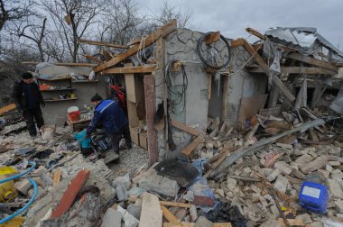 Zolochiv bölgesi, Ukrayna 9 Mart 2023. İnsanlar, Lviv bölgesindeki Zolochiv bölgesinde Rusya 'nın bir köyüne düzenlenen gece roket saldırısında yıkılan özel evlerin enkazlarını temizliyorlar.. 