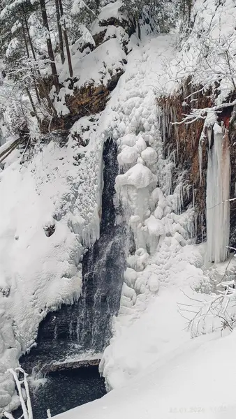 Huk waterfall, frozen waterfall at winter, Carpathian National Park, Gorgany mountain. Ukraine. Tourism destination, landmark . High quality photo