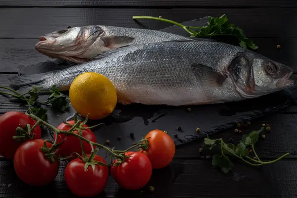 stock image Sea bream or dorado sea fish herbs on dark slate background Top view Mediterranean cuisine. High quality photo