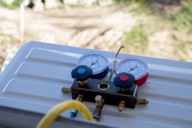 Klima, soğutucu ve soğutucu eklemek için gösterge kullanan havalandırma teknisyeni. yüksek kaliteli fotoğraf