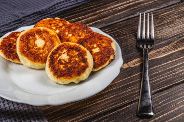 Beyaz tabakta taze kızarmış süzme peynirli gözleme.