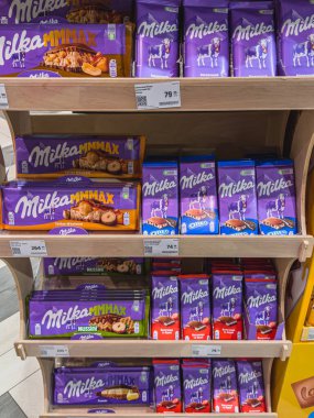 Lviv Ukrayna 03.04.25 çeşitli çikolata ürünleri bir perakende mağazasının raflarında düzenli bir şekilde düzenlenir, alışveriş ortamında canlı ambalajlar ve fiyatlandırma etiketleri sergilenir.