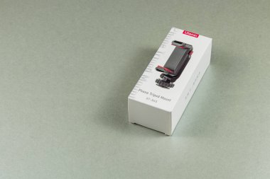 Lviv Ukrayna 05.04.25 akıllı telefonlar için tasarlanmış kompakt bir tripod bağlantısı düz bir yüzeyde dikey olarak sergilenmektedir. Paket, fotoğraf meraklıları için ideal özelliklerini gösteriyor..