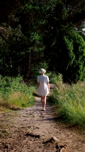 Blonde White Dress Walks Her Back Camera Forest Path — Stock Video