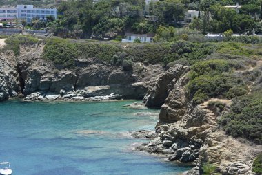 Girit adasının kayalık kayalıklarında açık mavi gökyüzü ile güzel dalgalar