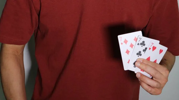 Close-up of a person holding playing cards